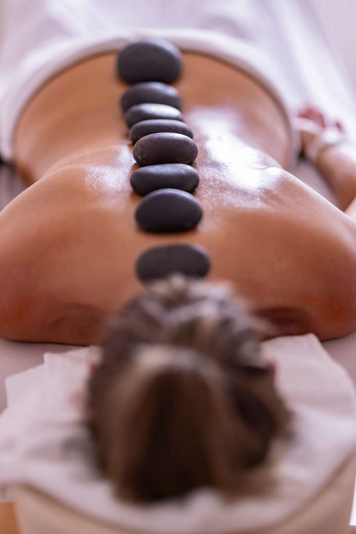 Teplé lávové kameny při masáži Hot Stones